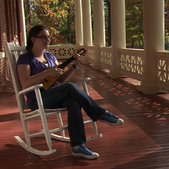 Still from Agnes Scott video of woman playing instrument outside